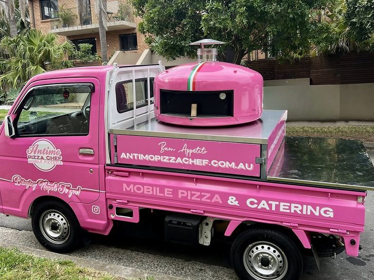 Our hot-pink Antimo Pizza Chef truck with its wood-fired oven, corporate pizza catering Sydney