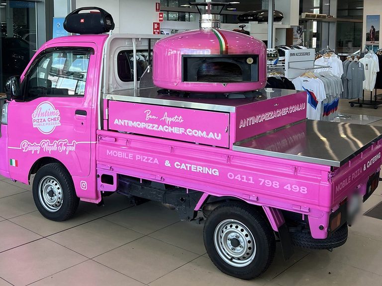 Antimo Pizza Chef pink pizza truck with its wood-fired oven in Sydney