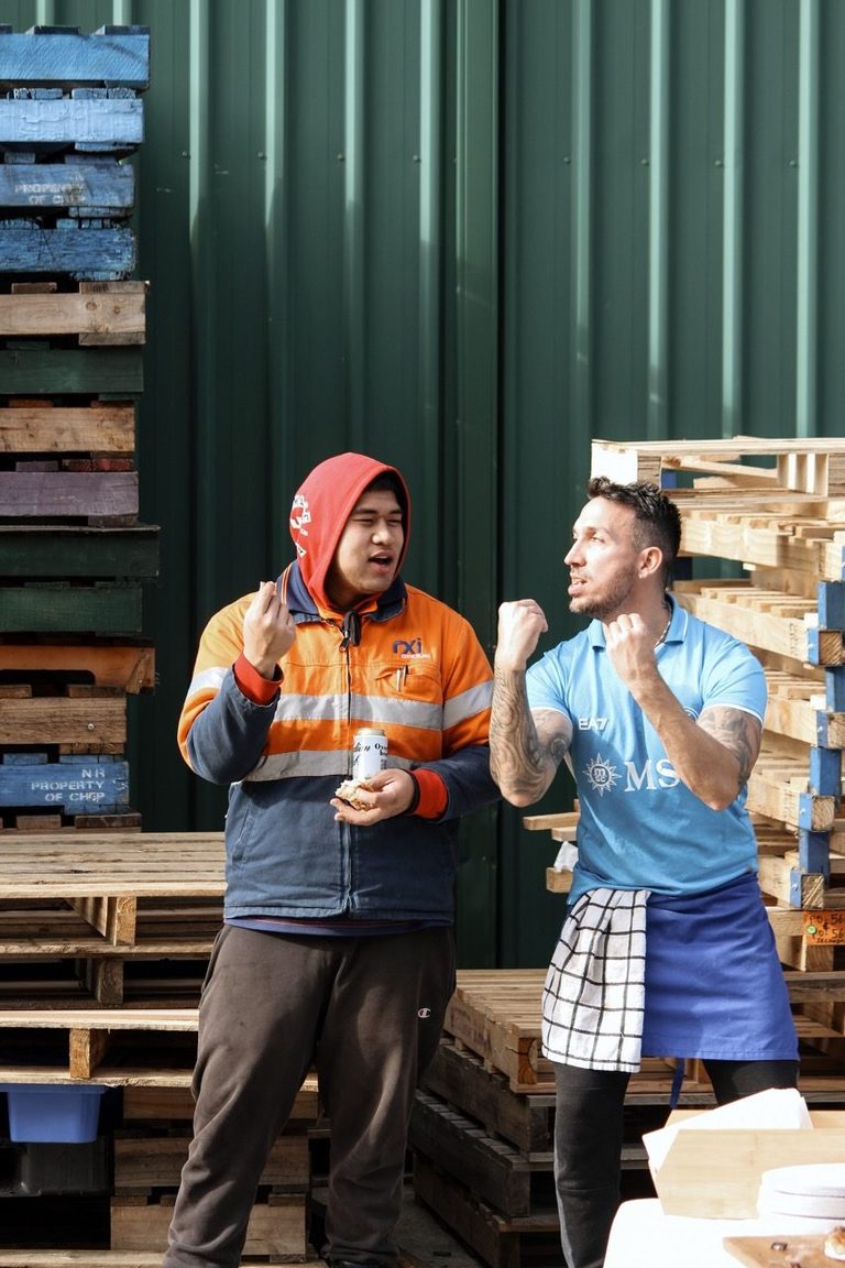 Our chef and a guest laughing at a pizza event