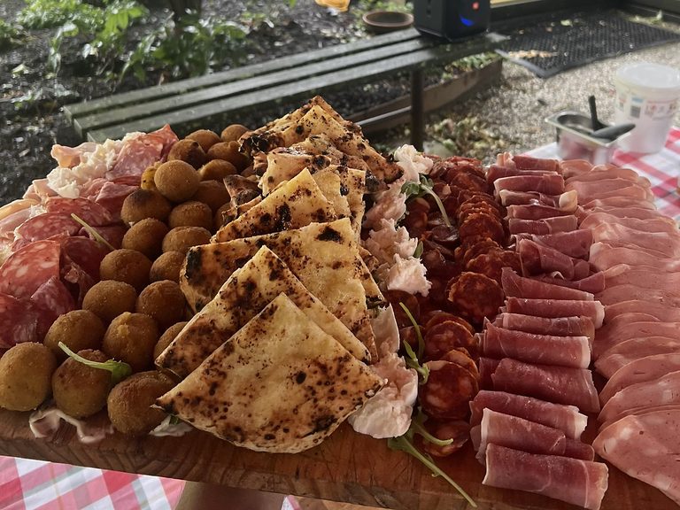 The Italian Feast platter with golden arancini, garlic focaccia, prosciutto and mozzarella for Sydney catering