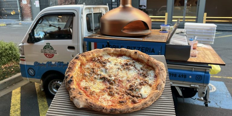 Wood-fired pizza in front of the Antimo Pizza Chef truck, pizza catering Adelaide CBD