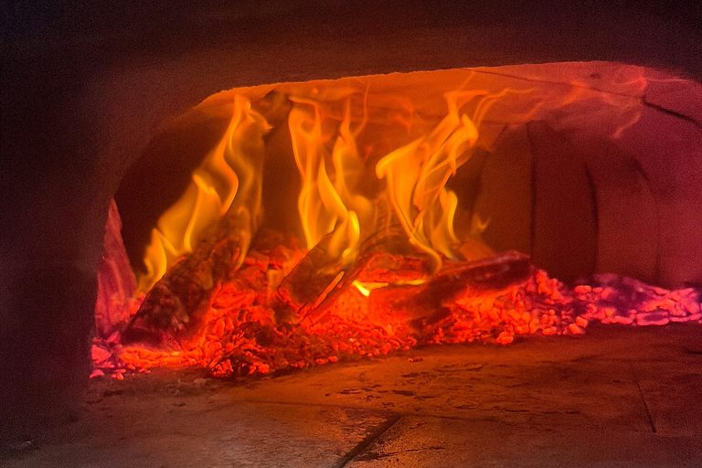 Flames and glowing embers inside a customer's own wood-fired oven (Own Oven set up, Melbourne)