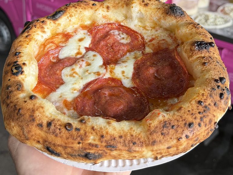 Wood-fired pepperoni pizza with a puffy, charred crust, pizza catering Sydney