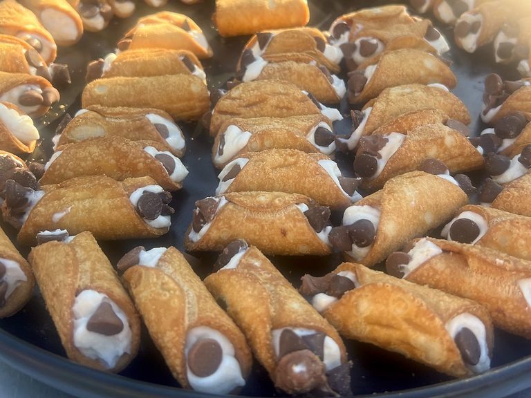 A tray of fresh cannoli with chocolate chips, a sweet add-on for Sydney office catering