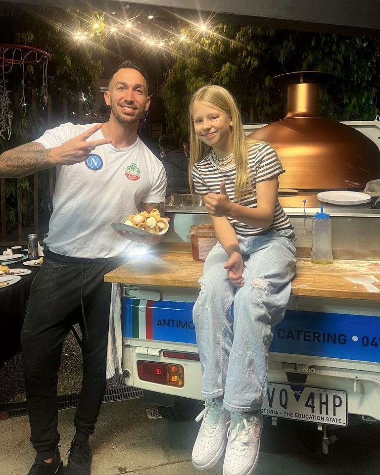Guests smiling with our chef at the copper-oven pizza truck, pizza catering Adelaide CBD