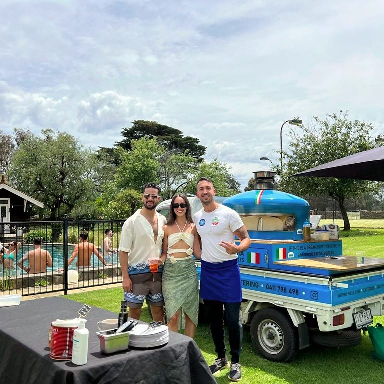 Hosts with our chef at the blue pizza truck at a garden party