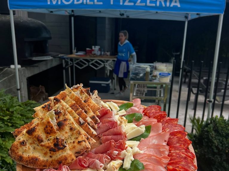 Antimo Pizza Chef blue marquee setup with portable Ooni ovens for tight driveways and backyards in Melbourne